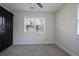 Comfortable bedroom with a ceiling fan, large window, and a modern black sliding door for the closet at 2222 Hill Nw St, Atlanta, GA 30318