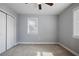This bedroom has carpeted floors, a large window, and a double-door closet, providing storage space at 2222 Hill Nw St, Atlanta, GA 30318