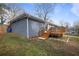 Back exterior view of a grey brick home with a deck and landscaped yard at 2222 Hill Nw St, Atlanta, GA 30318