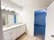 Bright bathroom featuring a double vanity with granite countertops and modern lighting at 5096 Cumberland Ct, Villa Rica, GA 30180