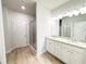 Bright bathroom features a double vanity with granite counters, wood-look floors, and bright lighting at 5096 Cumberland Ct, Villa Rica, GA 30180
