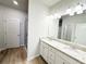 Bright bathroom features a double vanity with granite counters, wood-look floors, and bright lighting at 5096 Cumberland Ct, Villa Rica, GA 30180