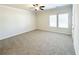 Large bedroom with plush carpet, a ceiling fan, and bright, natural light at 5096 Cumberland Ct, Villa Rica, GA 30180