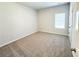 Cozy bedroom features neutral carpet and a window offering plenty of natural light at 5096 Cumberland Ct, Villa Rica, GA 30180