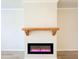 Modern fireplace with a wooden mantel, creating a cozy focal point in the living room at 5096 Cumberland Ct, Villa Rica, GA 30180