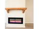 Modern electric fireplace with wooden mantel adds warmth and style to the living space at 5096 Cumberland Ct, Villa Rica, GA 30180