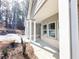 Charming covered front porch with white columns and a brick base, perfect for relaxing outdoors at 5096 Cumberland Ct, Villa Rica, GA 30180