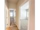 Carpeted bedrooms are shown from the hallway with neutral wall paint and bright lighting at 5096 Cumberland Ct, Villa Rica, GA 30180