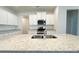 Close up of a kitchen island featuring a double sink and granite countertops at 5096 Cumberland Ct, Villa Rica, GA 30180