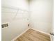 Laundry room is ready with washer/dryer hookups and a wire rack for additional storage at 5096 Cumberland Ct, Villa Rica, GA 30180