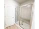 Modern bathroom with large glass shower and wood-look floors at 5096 Cumberland Ct, Villa Rica, GA 30180