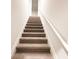 Carpeted staircase with white railings leads to the upper level of the home at 5096 Cumberland Ct, Villa Rica, GA 30180