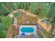 Aerial view featuring a pool, putting green, playground, and picnic shelter for outdoor enjoyment at 608 Red Leaf Way, Canton, GA 30114