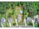 Aerial view showcasing the property's layout, pool, and expansive surroundings with mature trees at 608 Red Leaf Way, Canton, GA 30114