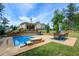 Backyard features a pool, patio, and landscaping with a view of the home's exterior at 608 Red Leaf Way, Canton, GA 30114