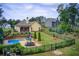 Spacious backyard with a pool, patio area, and lush landscaping, ideal for entertaining and relaxation at 608 Red Leaf Way, Canton, GA 30114