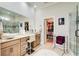 Bright bathroom features double sinks, granite counters, a walk-in shower, and a walk-in closet at 608 Red Leaf Way, Canton, GA 30114