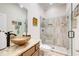 Modern bathroom features glass walk-in shower with decorative tile accents and vessel sink with granite countertops at 608 Red Leaf Way, Canton, GA 30114