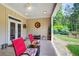 Relaxing covered patio with comfortable seating, perfect for enjoying the outdoors and overlooking the yard at 608 Red Leaf Way, Canton, GA 30114