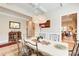 Bright dining room with crystal chandelier and seating for six at 608 Red Leaf Way, Canton, GA 30114