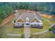 Stunning exterior elevation showcasing a meticulously landscaped front yard and charming architectural details at 608 Red Leaf Way, Canton, GA 30114