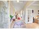 Bright foyer features decorative glass door, neutral walls, wood-look floors, and colorful area rugs at 608 Red Leaf Way, Canton, GA 30114