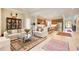 Open-concept living space with hardwood floors connecting the living room, dining area, and modern kitchen at 608 Red Leaf Way, Canton, GA 30114