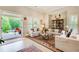 Inviting living room with neutral tones, glass table, and access to the outdoor patio at 608 Red Leaf Way, Canton, GA 30114