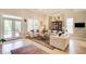 Bright living room features tall ceilings, a ceiling fan, hardwood floors, and doors to the outside at 608 Red Leaf Way, Canton, GA 30114