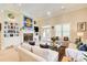Bright living room features tall ceilings, a ceiling fan, hardwood floors, and a fireplace at 608 Red Leaf Way, Canton, GA 30114