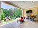 Covered patio with outdoor seating and a view of the pool and landscaped backyard at 608 Red Leaf Way, Canton, GA 30114
