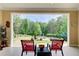 Cozy patio seating area overlooking the lush, private backyard with mature trees at 608 Red Leaf Way, Canton, GA 30114