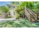 Back of house with second story deck and access stairs, driveway, and landscaping in the backyard at 1157 Alta Ne Ave, Atlanta, GA 30307