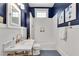 Stylish bathroom showcasing navy blue walls, white tile shower, and marble countertop with brass accents at 1157 Alta Ne Ave, Atlanta, GA 30307