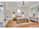 Light-filled bedroom with hardwood floors, neutral decor, complemented by natural light from large windows at 1157 Alta Ne Ave, Atlanta, GA 30307