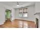 Bedroom with wood floors, neutral walls, ceiling fan, fireplace and bright window light at 1157 Alta Ne Ave, Atlanta, GA 30307