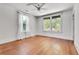 Bedroom with neutral walls, ceiling fan, hardwood floors, and bright window light at 1157 Alta Ne Ave, Atlanta, GA 30307