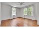 Bright bedroom with hardwood floors and large windows dressed with light curtains at 1157 Alta Ne Ave, Atlanta, GA 30307