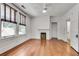 Bedroom with hardwood floors, fireplace, neutral walls, ceiling fan, and bright window light at 1157 Alta Ne Ave, Atlanta, GA 30307