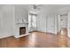 Bright bedroom featuring hardwood floors, a classic fireplace, and ceiling fan at 1157 Alta Ne Ave, Atlanta, GA 30307
