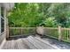 Wooden deck with wood railing surrounded by lush greenery at 1157 Alta Ne Ave, Atlanta, GA 30307