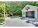 Detached garage with basketball hoop, black garage door and door with windows. Access to a 2nd story deck at 1157 Alta Ne Ave, Atlanta, GA 30307