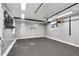 Clean, freshly painted garage with drop down attic access, painted floor, and tool and storage racks at 1157 Alta Ne Ave, Atlanta, GA 30307