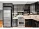 Kitchen featuring stainless steel appliances, subway tile backsplash and black cabinets at 1157 Alta Ne Ave, Atlanta, GA 30307