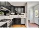 Renovated kitchen showcasing white countertops, stainless steel appliances, and black cabinets at 1157 Alta Ne Ave, Atlanta, GA 30307