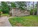 Home featuring a spacious backyard with a raised patio and mature trees at 1304 Anchor Sw Ter, Atlanta, GA 30311