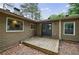 Backyard view of the home with a wooden deck and the exterior featuring neutral siding and black trim at 1304 Anchor Sw Ter, Atlanta, GA 30311