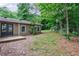 Backyard featuring a wooden deck, lush trees, and a garden at 1304 Anchor Sw Ter, Atlanta, GA 30311
