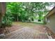 Spacious backyard with a wooden deck and mature shade trees at 1304 Anchor Sw Ter, Atlanta, GA 30311