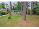 Landscaped backyard featuring mature trees and green lawn at 1304 Anchor Sw Ter, Atlanta, GA 30311
